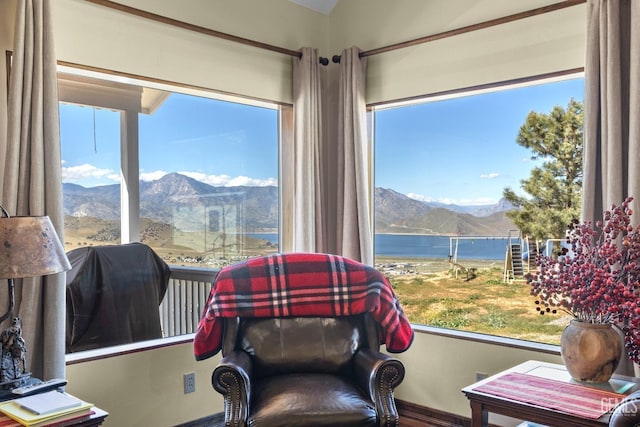 sitting room featuring a water and mountain view