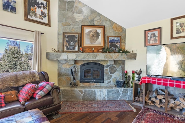 living room featuring a fireplace, hardwood / wood-style floors, and vaulted ceiling