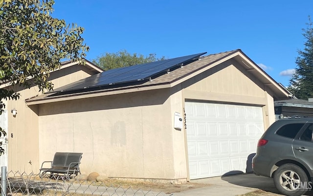 view of side of property featuring solar panels