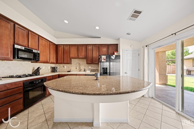13421 Cheyenne Mountain Dr, Bakersfield, CA 93314 - kitchen featuring black appliances, lofted ceiling, backsplash, light tile patterned flooring, and recessed lighting