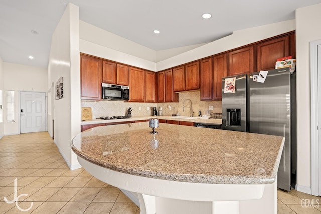 13421 Cheyenne Mountain Dr, Bakersfield, CA 93314 - kitchen with black appliances, light tile patterned floors, tasteful backsplash, a sink, and light stone countertops