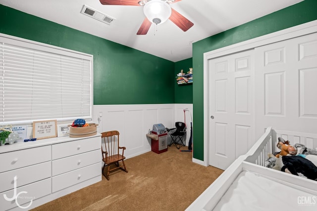 13421 Cheyenne Mountain Dr, Bakersfield, CA 93314 - bedroom with carpet flooring, a wainscoted wall, a closet, a crib, and ceiling fan