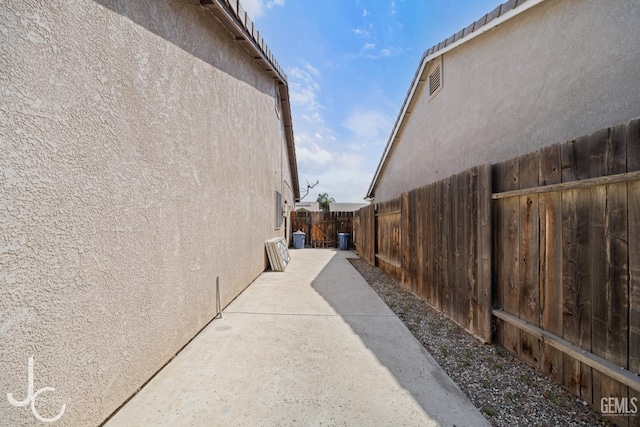 13421 Cheyenne Mountain Dr, Bakersfield, CA 93314 - view of property exterior featuring stucco siding, a fenced backyard, and a patio