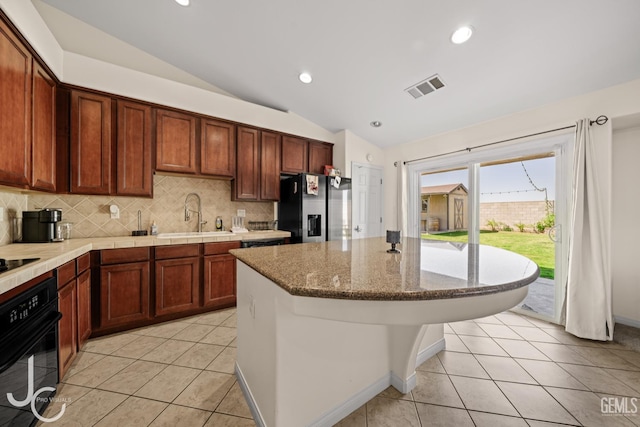 13421 Cheyenne Mountain Dr, Bakersfield, CA 93314 - kitchen featuring stainless steel fridge, a sink, lofted ceiling, black oven, and backsplash