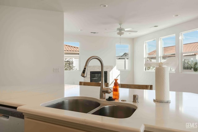14209 Boon Way, Bakersfield, CA 93311 - kitchen featuring a tile fireplace, dishwasher, sink, and a healthy amount of sunlight