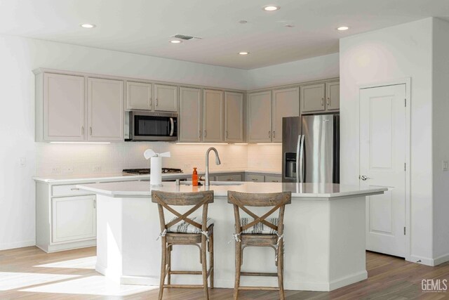 14209 Boon Way, Bakersfield, CA 93311 - kitchen featuring sink, a center island with sink, light hardwood / wood-style floors, and appliances with stainless steel finishes