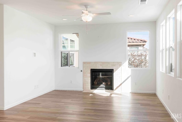 14209 Boon Way, Bakersfield, CA 93311 - unfurnished living room with ceiling fan, a fireplace, and light hardwood / wood-style floors