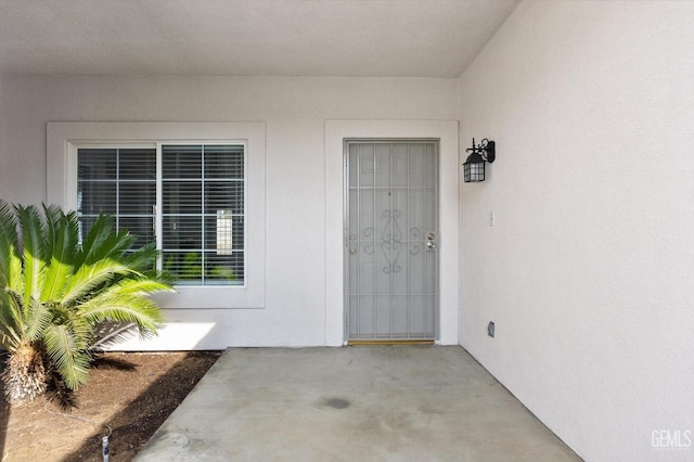 entrance to property featuring a patio area