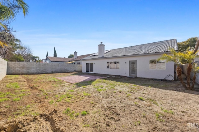 back of house featuring a patio area and a lawn