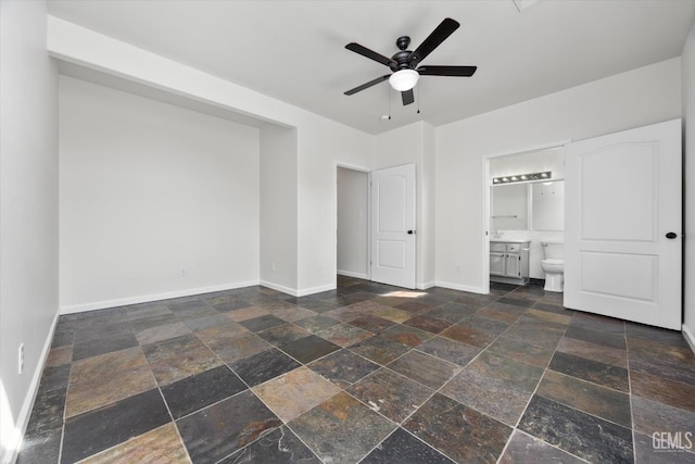 unfurnished bedroom with ceiling fan and ensuite bathroom