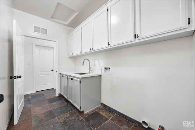 laundry room featuring washer hookup, sink, and cabinets