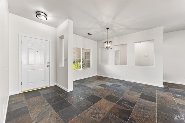 foyer entrance featuring a chandelier