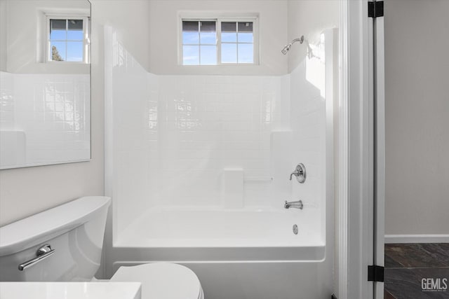 bathroom with a wealth of natural light,  shower combination, and toilet