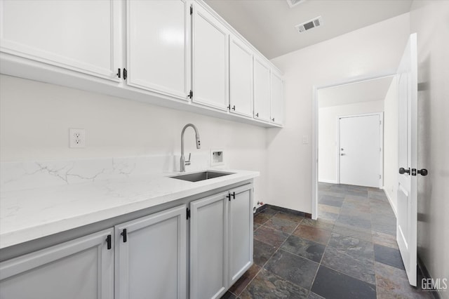 laundry area with cabinets, washer hookup, and sink