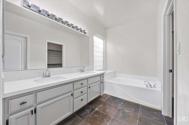 bathroom featuring vanity and a bathtub