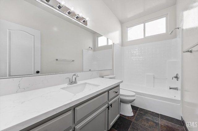 full bathroom featuring toilet, vanity, and bathtub / shower combination