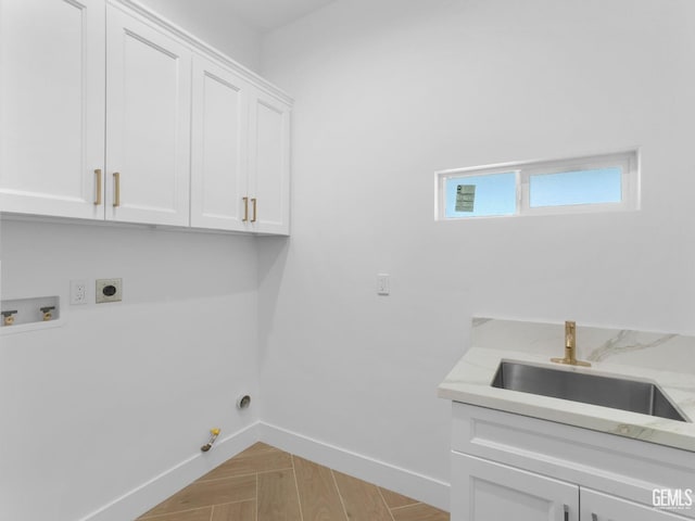 laundry room with cabinet space, gas dryer hookup, a sink, hookup for a washing machine, and electric dryer hookup