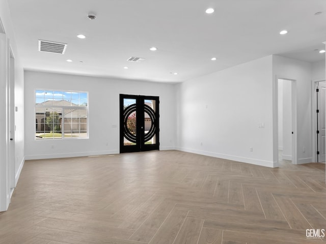 unfurnished room with baseboards, french doors, visible vents, and recessed lighting