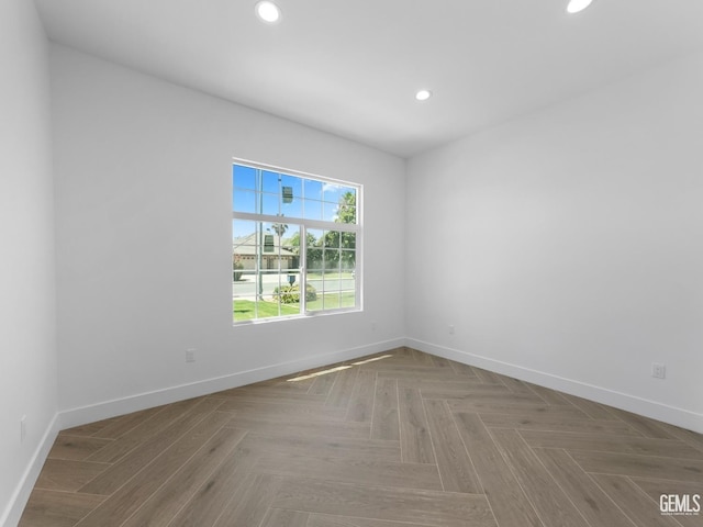 unfurnished room featuring recessed lighting and baseboards