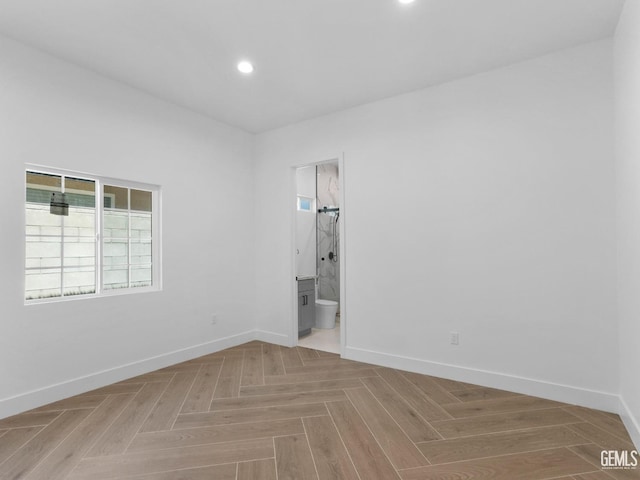 unfurnished room featuring baseboards and recessed lighting