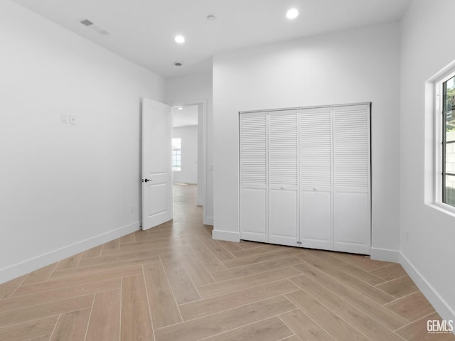 unfurnished bedroom with recessed lighting, multiple windows, and baseboards