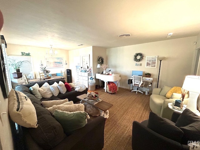 living room featuring carpet and an inviting chandelier