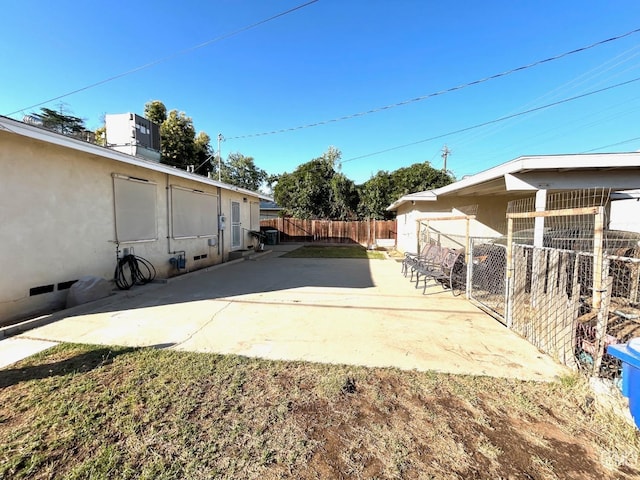 view of yard featuring central air condition unit and a patio