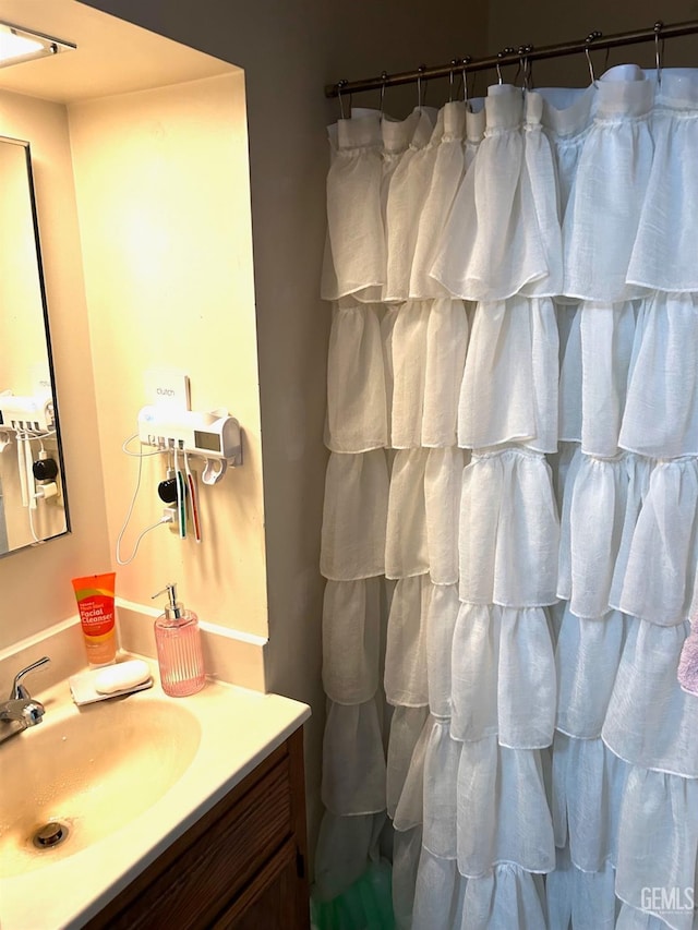 bathroom featuring vanity and a shower with shower curtain