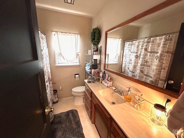 bathroom featuring toilet and vanity