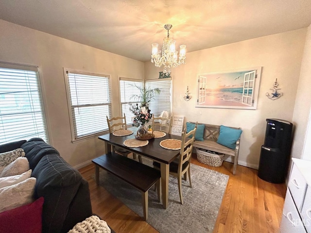 dining area featuring a chandelier and wood-type flooring