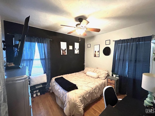 bedroom featuring hardwood / wood-style flooring and ceiling fan