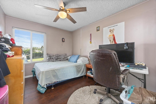 bedroom with a textured ceiling, dark hardwood / wood-style flooring, and ceiling fan