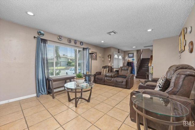 living room featuring light tile patterned floors and a textured ceiling