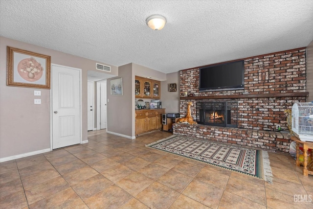 living room featuring a textured ceiling and a brick fireplace