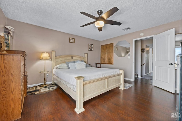 bedroom featuring a textured ceiling, dark hardwood / wood-style flooring, and ceiling fan