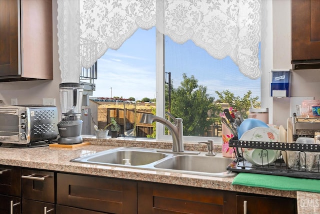 kitchen with sink and dark brown cabinets