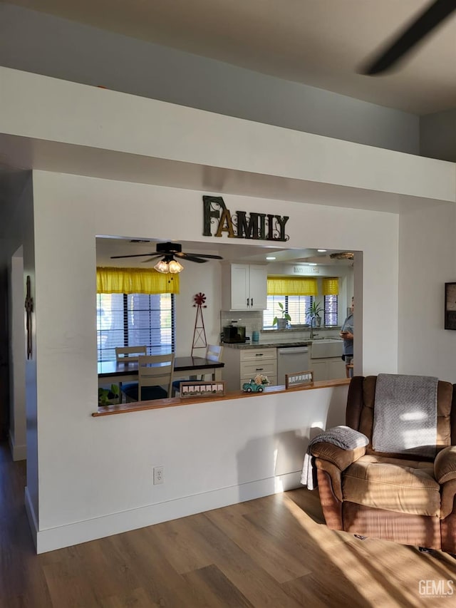 9101 Kern Island St, Bakersfield, CA 93307 - kitchen featuring dishwashing machine, dark wood-style flooring, white cabinets, and a ceiling fan