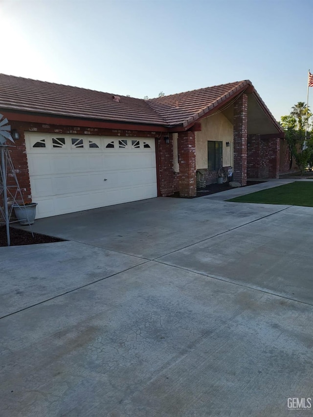 9101 Kern Island St, Bakersfield, CA 93307 - single story home with driveway, a tile roof, a garage, and brick siding