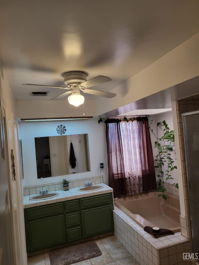 9101 Kern Island St, Bakersfield, CA 93307 - full bathroom featuring a bath, double vanity, a ceiling fan, a shower with door, and tile patterned floors