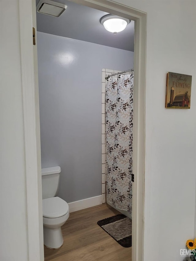 9101 Kern Island St, Bakersfield, CA 93307 - full bath featuring wood finished floors and curtained shower