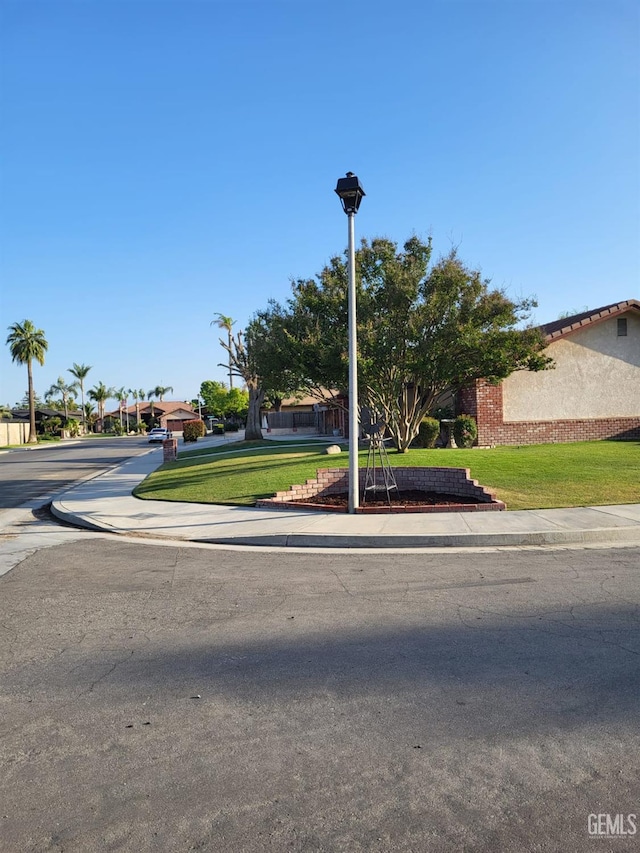 9101 Kern Island St, Bakersfield, CA 93307 - obstructed view of property featuring a front lawn