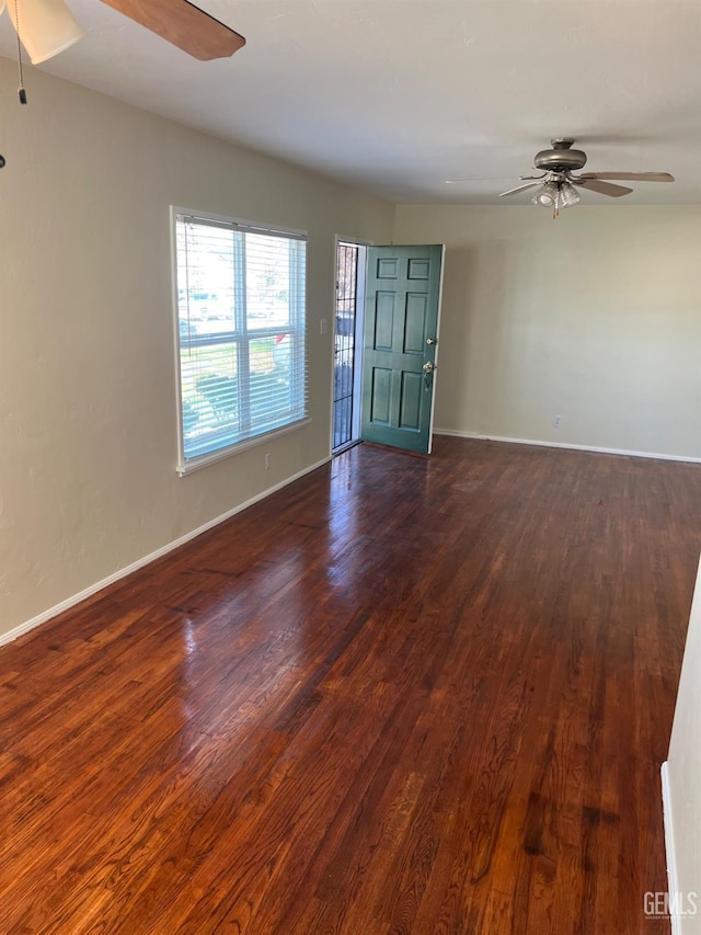 unfurnished room featuring dark wood-type flooring and ceiling fan