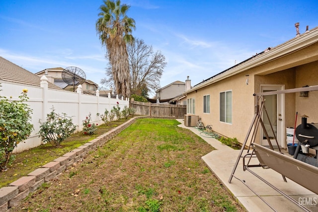 view of yard featuring a patio and central AC