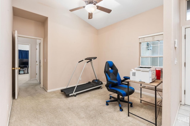 carpeted office space with vaulted ceiling, ceiling fan, and plenty of natural light