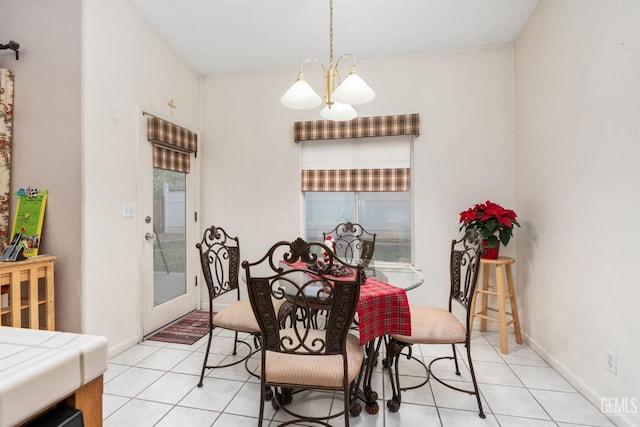 dining space with light tile patterned flooring and an inviting chandelier