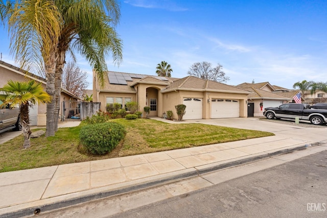 single story home with a garage, a front yard, and solar panels