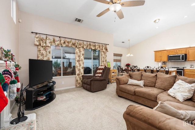 living room featuring ceiling fan, a healthy amount of sunlight, light colored carpet, and lofted ceiling