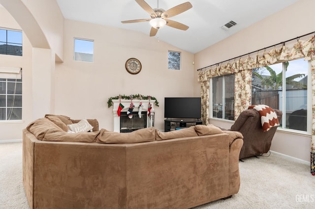 carpeted living room featuring vaulted ceiling and ceiling fan