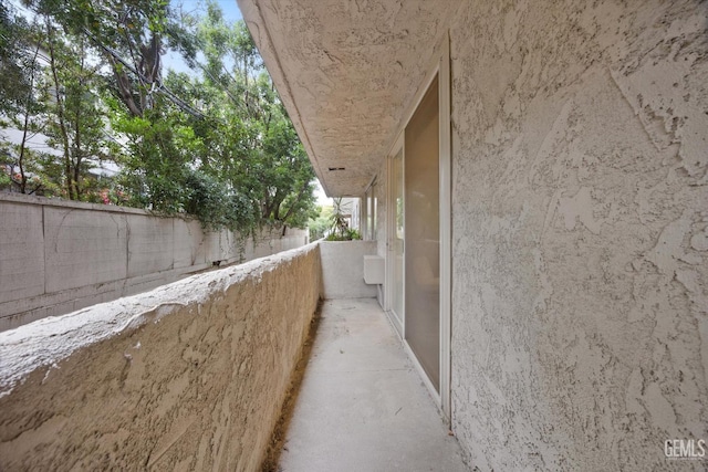 view of property exterior featuring stucco siding and fence