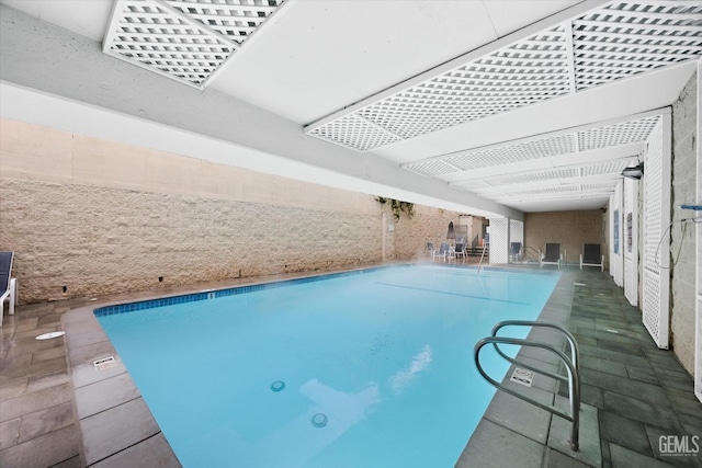 pool featuring a patio area and a pergola